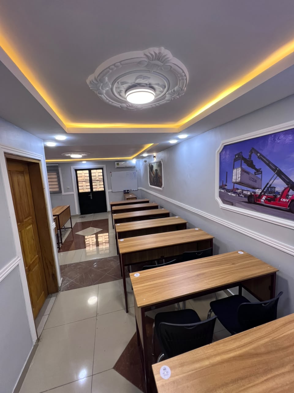 Salle de formation équipée de tableau blanc et de pupitres individuels